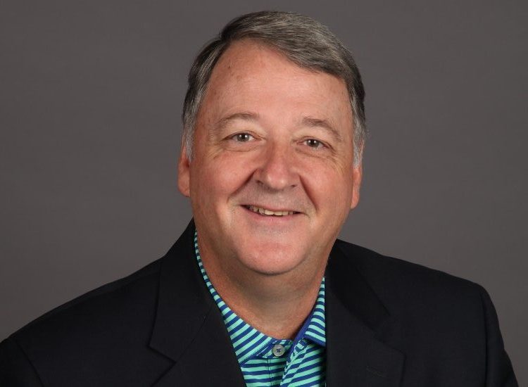 Portrait of John Carson, Executive Director of AltusGroup