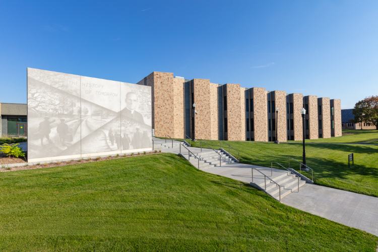 Boys Town School exterior showing varied surface treatments of High Performance Insulated Wall Panels and large Graphic Concrete featuring Boys Town history